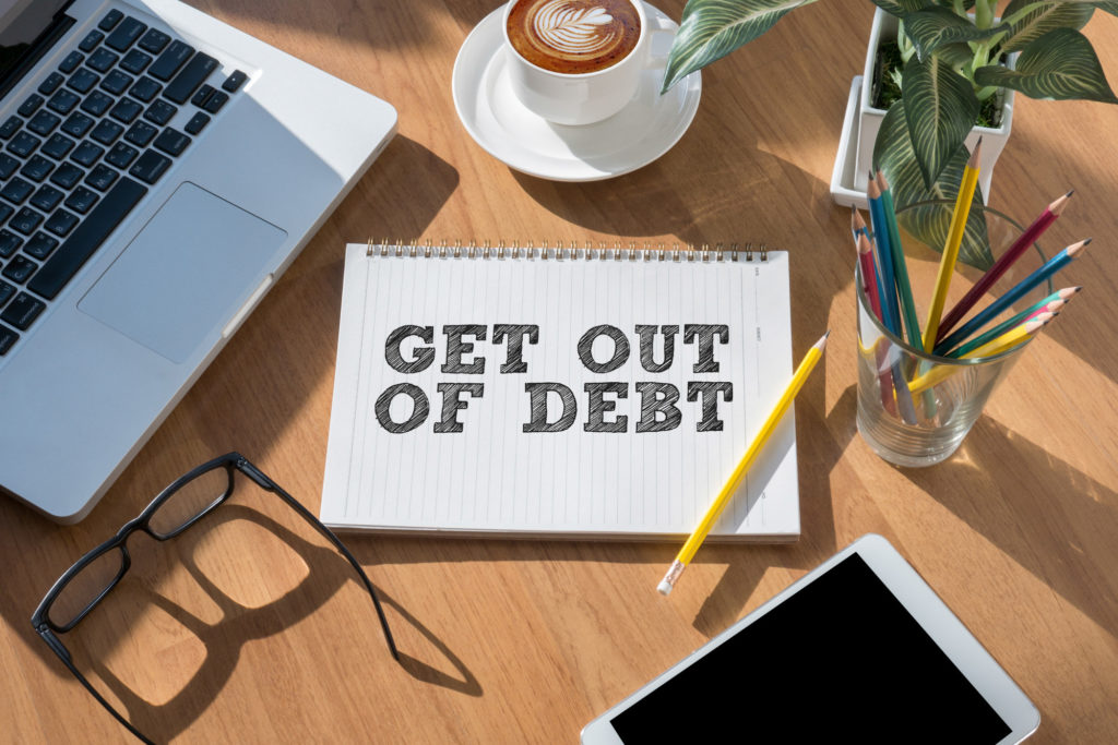 What is a Debt Consolidation Loan?, Image wording on a pad get out of debt