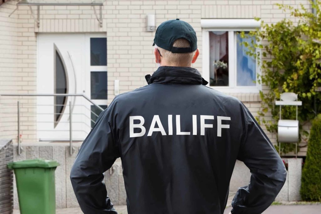 Bailiff looks at a property
